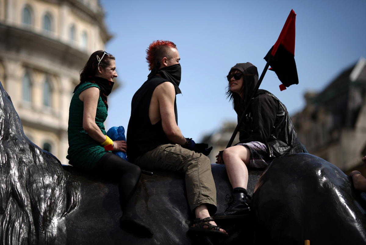 Demonstrators sit on a lion statue in Trafalgar Square during the annual May Day march on May 1, 2015. Hundreds attended the traditional rally in London, which is an annual celebration of laborers and the working classes and is promoted by the international labor movement, anarchists, socialists, and communists across the world. (Dan Kitwood/Getty Images)