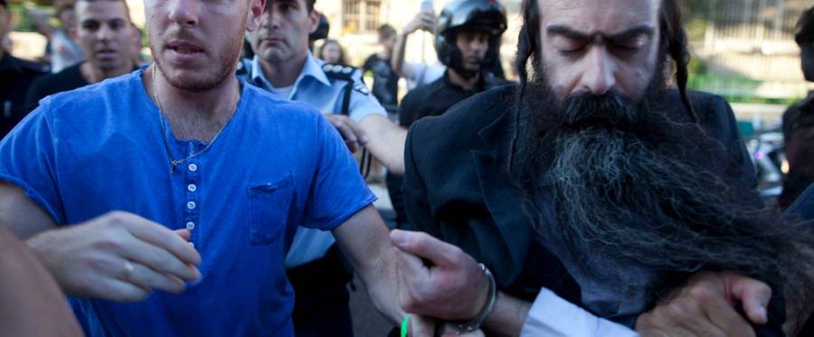 Israeli Policemen arrest an ultra-Orthodox Jewish man suspected of stabbing participants of the Gay Pride Parade  in Jerusalem, Israel, July 30, 2015. 