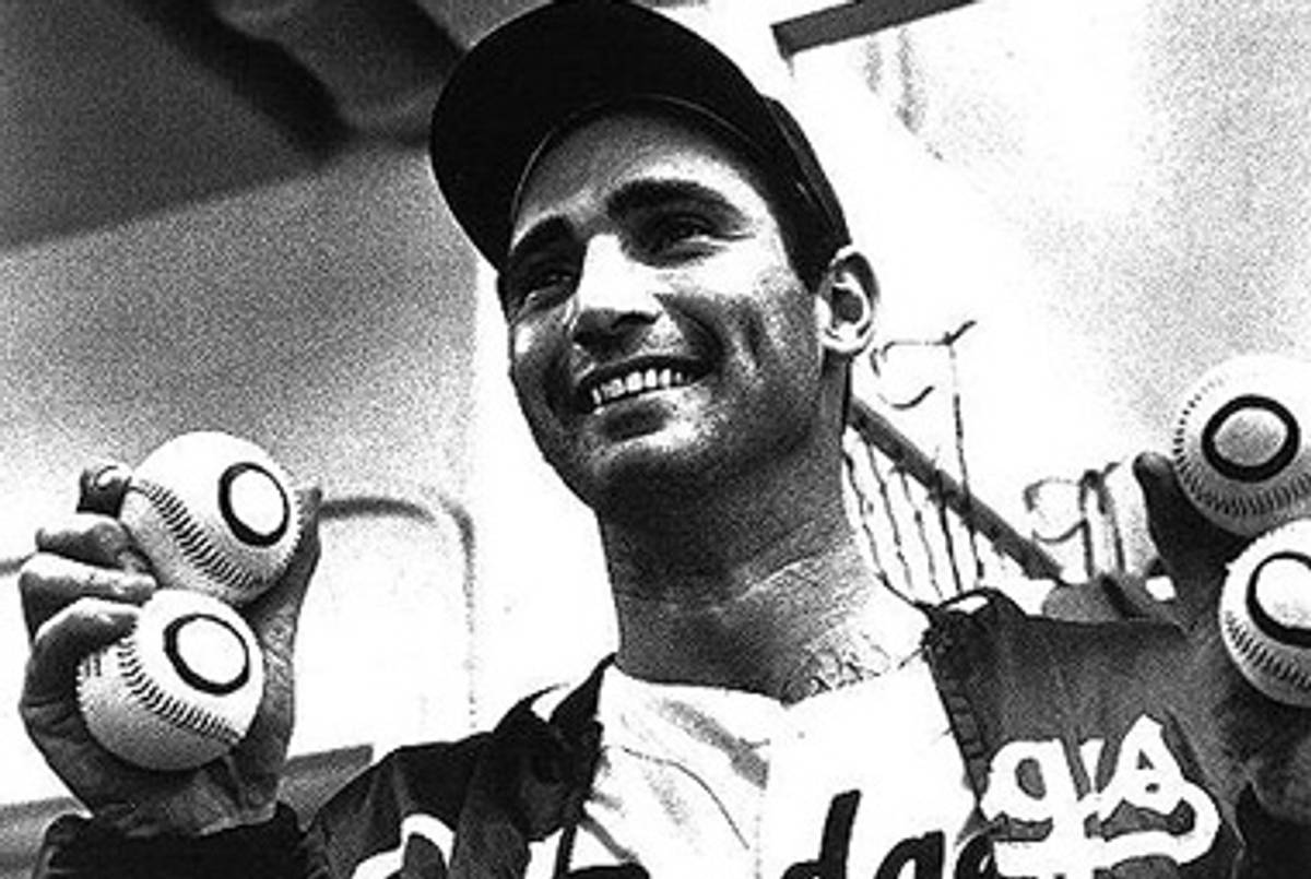 Sandy Koufax holding one ball for each of his no-hitters.(Jewish Journal)