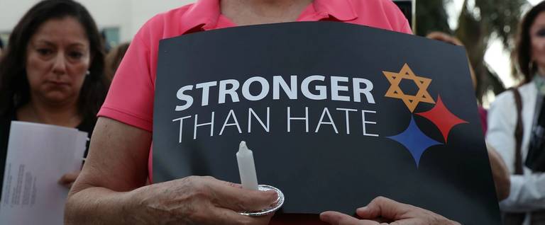 A person holds a sign that reads, 'Stronger Than Hate,' at the Holocaust Memorial Miami Beach vigil for the victims in Pittsburgh.