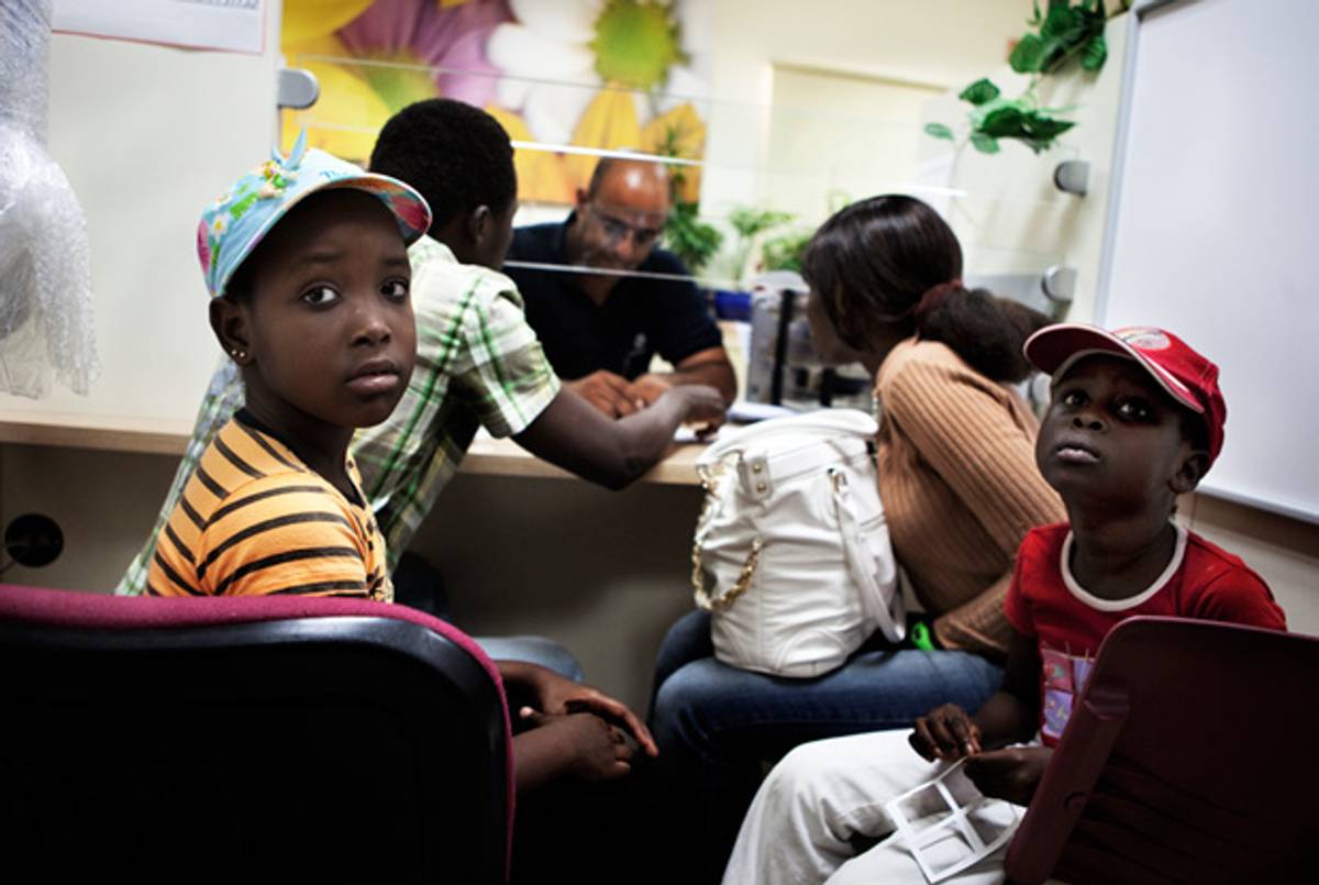 A South Sudanese migrant family at the Immigration Population Authority office in Eilat on June 12, 2012.(Menhame Kahana/AFP/Getty Images)