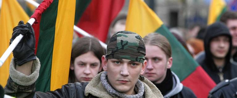 Participants of nationalist organizations hold the national flag during a rally in Vilnius on March 11, 2009.