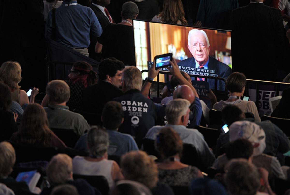 Supporters take pictures of the giant screen projecting a video address by former President Jimmy Carter on September 4, 2012 at the Democratic National Convention.(MLADEN ANTONOV/AFP/GettyImages)