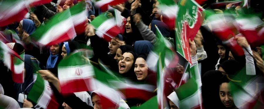 Iranian schoolgirls wave their national flag during the 36th anniversary of the Islamic revolution in Tehran's Azadi Square (Freedom Square), Tehran, Iran, February 11, 2015. 