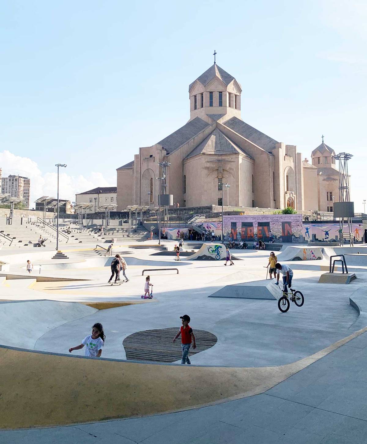 A skate park in front of a Yerevan cathedral 