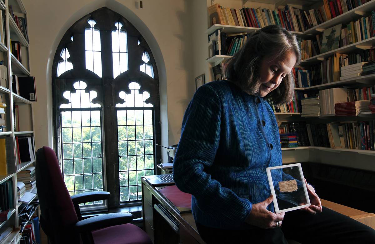 Karen L. King, Hollis Professor of Divinity at Harvard University, in her office with a papyrus fragment of the Gospel of Jesus’ Wife