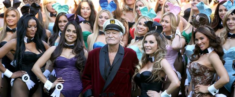 Hugh Hefner (C) poses with Playboy Bunnies Playmate of the Year 2013 Raquel Pomplun (2nd L) and Miss December 2009 Crystal Hefner (2nd R) at Playboy's 60th Anniversary special event on January 16, 2014 in Los Angeles, California.