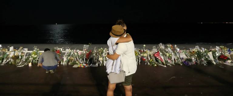 Two people hold each other by the new makeshift memorial  in Nice, France, July 18, 2016. 