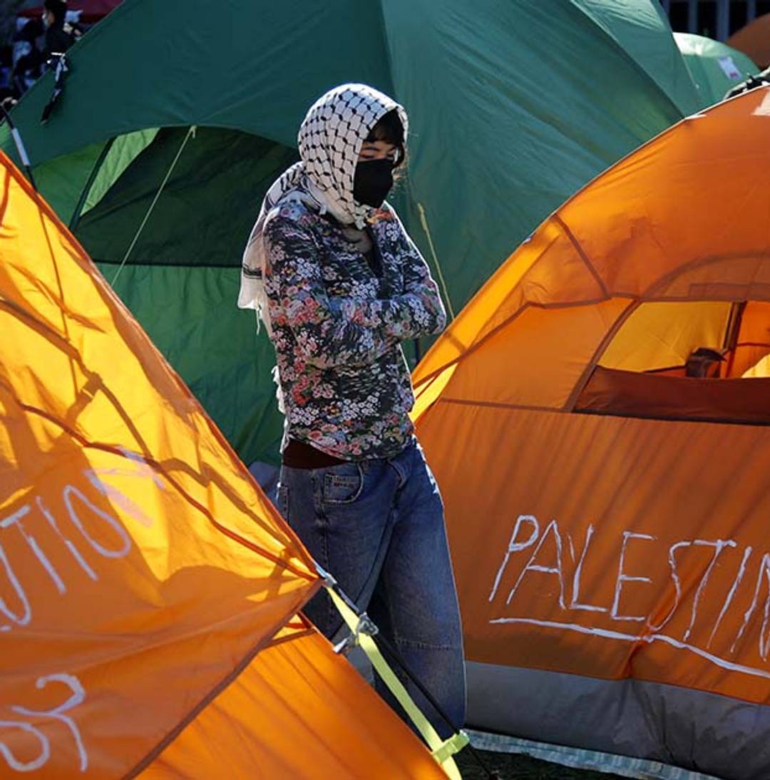 A person stands among tents at an encampment set up by pro-Palestinian protesters on the campus of Columbia University in New York on April 25, 2024