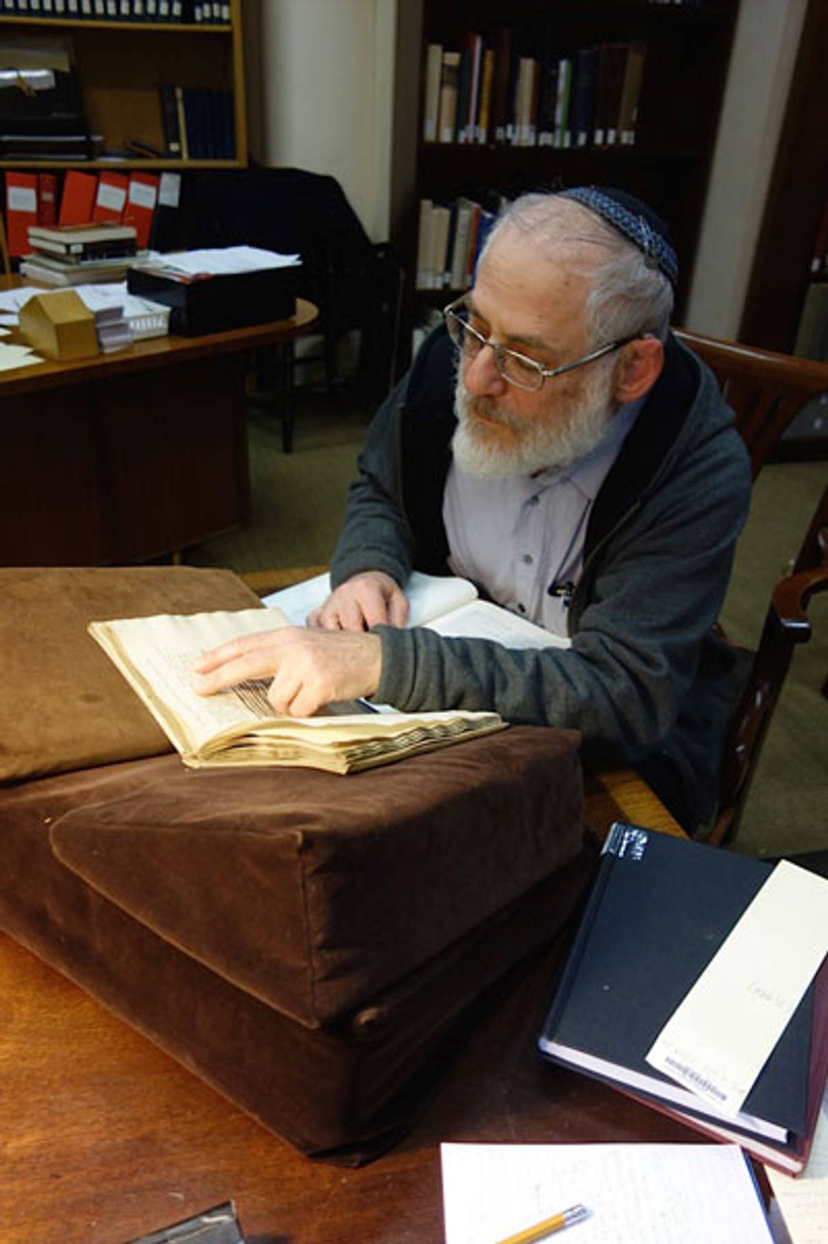 Jay Rovner, manuscripts bibliographer at the Jewish Theological Seminary Library in New York, examines a volume confirmed by internal stamps to have belonged to the Jewish library of Rome. (All photos: Michael Frank)