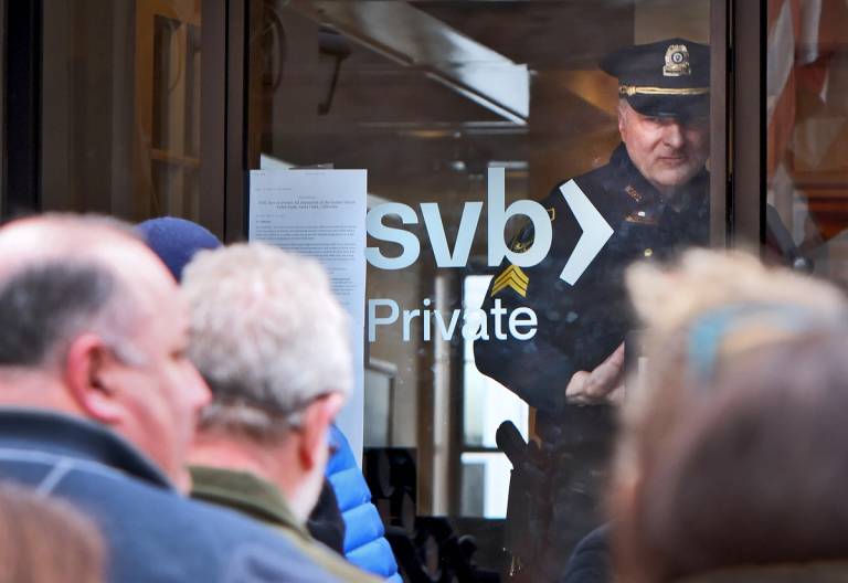Customers line up at SVB in Wellesley, Massachusetts, on Monday, March 13, 2023