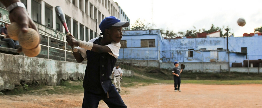 Cuban children play baseball in Havana, on March 16, 2016. 