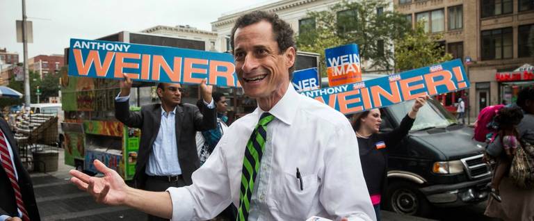 Anthony Weiner meets with people on a street corner in Harlem in New York City during his run for mayor, September 10, 2013. 