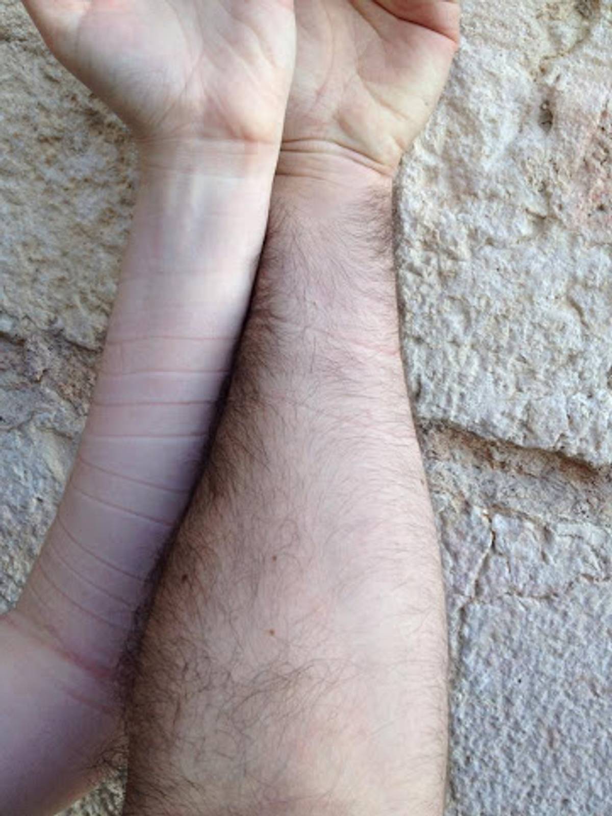 The author and her husband’s arms, after laying tefillin together at Robinson’s Arch, the egalitarian section behind the Kotel in 2014. (Image: Michael Spitzer-Rubenstein)