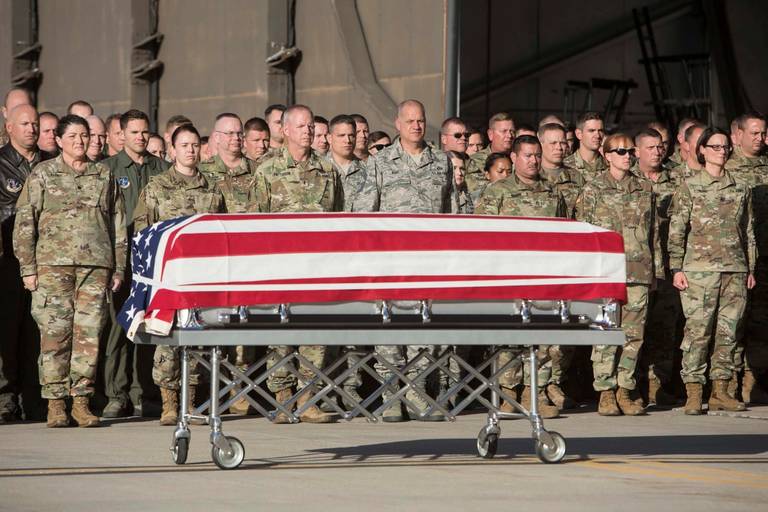 Members of the Utah National Guard stand at attention as the casket containing the remains of Maj. Brent R. Taylor arrives at Roland Wright Air National Guard Base in Salt Lake City on Nov. 14, 2018. Taylor, 39, the mayor of North Ogden, Utah, died in Afghanistan of wounds sustained from small arms fire.