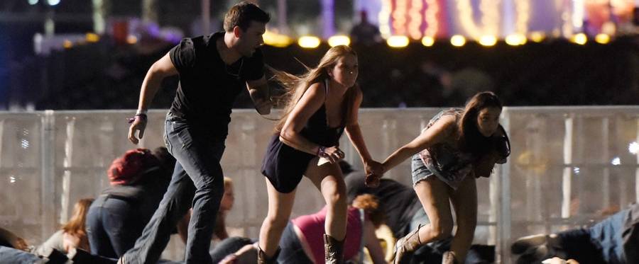 People run from the Route 91 Harvest country music festival after apparent gun fire was hear on October 1, 2017 in Las Vegas, Nevada. A gunman has opened fire on a music festival in Las Vegas, leaving at least 20 people dead and more than 100 injured.