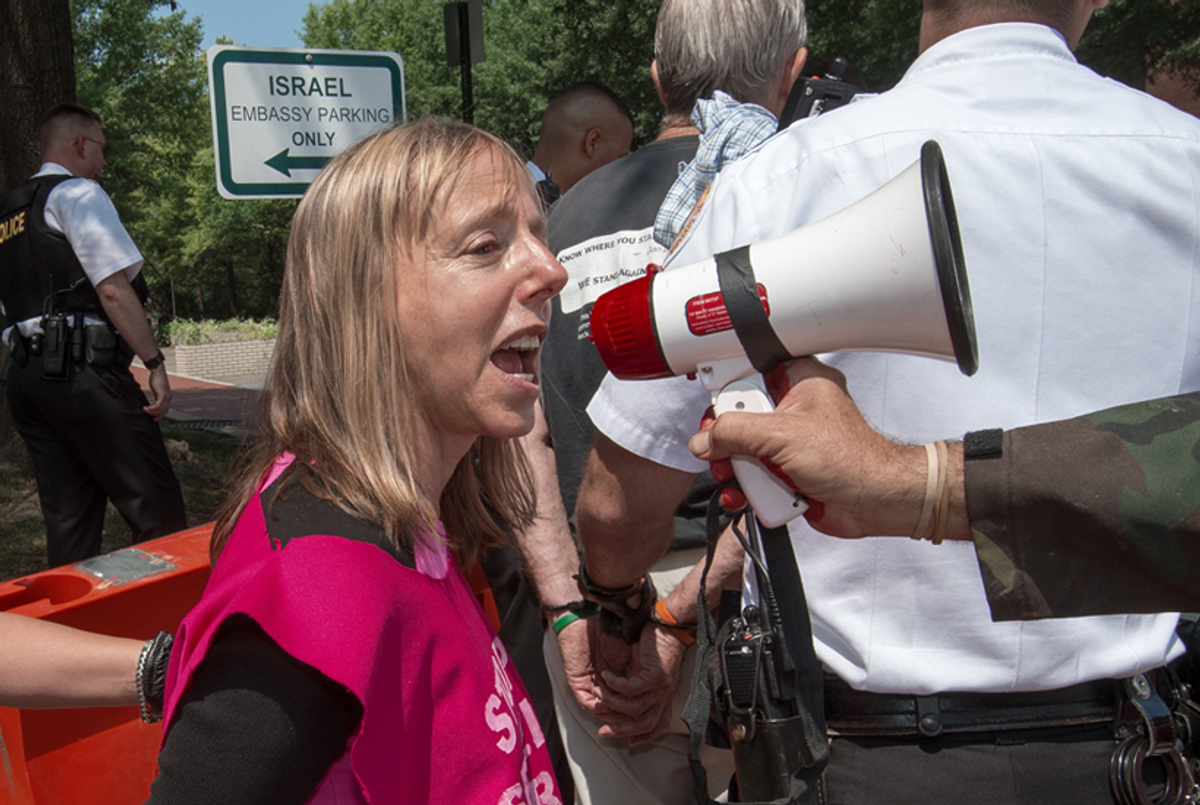 Medea Benjamin, after being arrested during a 'die-in' to protest the deaths of Palestinians in Gaza, July 30, 2014. (PAUL J. RICHARDS/AFP/Getty Images)