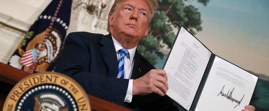 U.S. President Donald Trump holds up a memorandum that reinstates sanctions on Iran after he announced his decision to withdraw the United States from the 2015 Iran nuclear deal in the Diplomatic Room at the White House May 8, 2018 in Washington, DC.