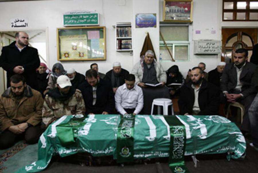 Mourners pray over the flag-draped coffin of Mahmoud al-Mabhouh, January 29, 2010.(Louai Beshara/AFP/Getty Images)