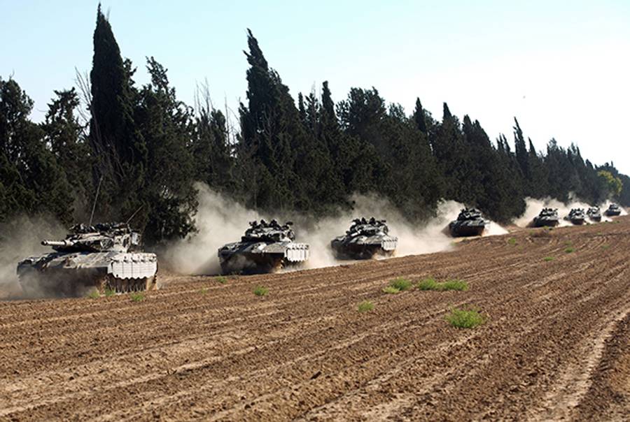 A convoy of Israeli Merkava tanks roll near Israel's border with the Gaza Strip on July 11, 2014. (MENAHEM KAHANA/AFP/Getty Images)