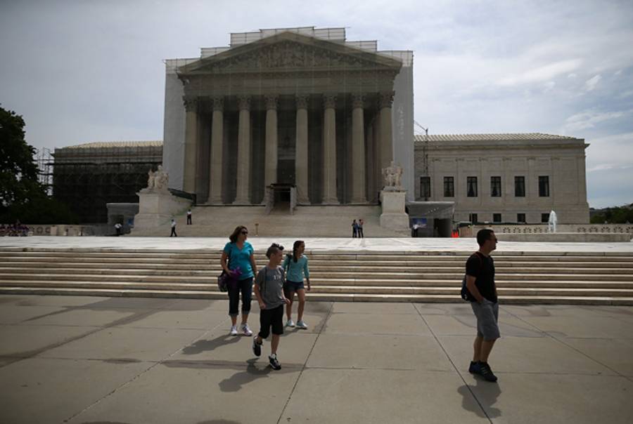 People walk past the U.S. Supreme Court building June 13, 2013 in Washington, DC.(Mark Wilson/Getty Images)