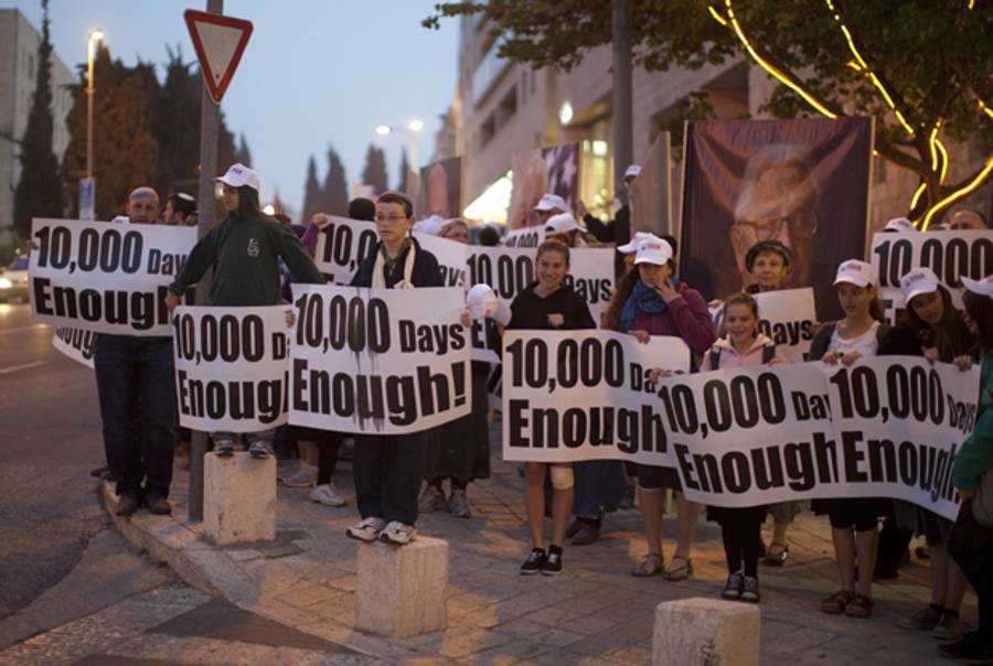 A woman holds a placard during a protest calling for the release of Jonathan Pollard, a Jewish American who was jailed for life in 1987 on charges of spying on the United States, during a protest outside US Secretary of State John Kerry's hotel in Jerusalem on April 8, 2013. (AHMAD GHARABLI/AFP/Getty Images)