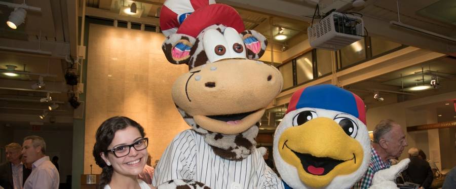 Staten Island Yankees mascot Scooter the Holy Cow (M) and Brooklyn Cyclones mascot Pee Wee (R) post with an employee of the Staten Island Yankees at the Center for Jewish History, June 15, 2016. 