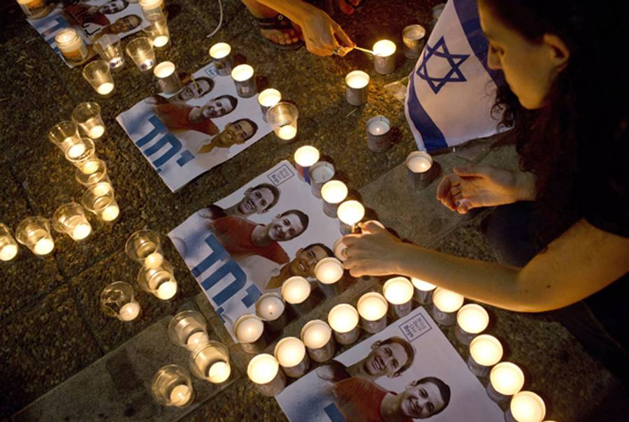 Israelis light candles in Rabin Square in Tel Aviv on June 30, 2014 after the announcement that the bodies of three kidnapped Israeli teenagers had been found near Hebron. (OREN ZIV/AFP/Getty Images)