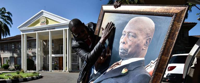 A man holding a portrait of the late former president of Kenya, Daniel arap Moi, in Nakuru on Feb. 7, 2020 