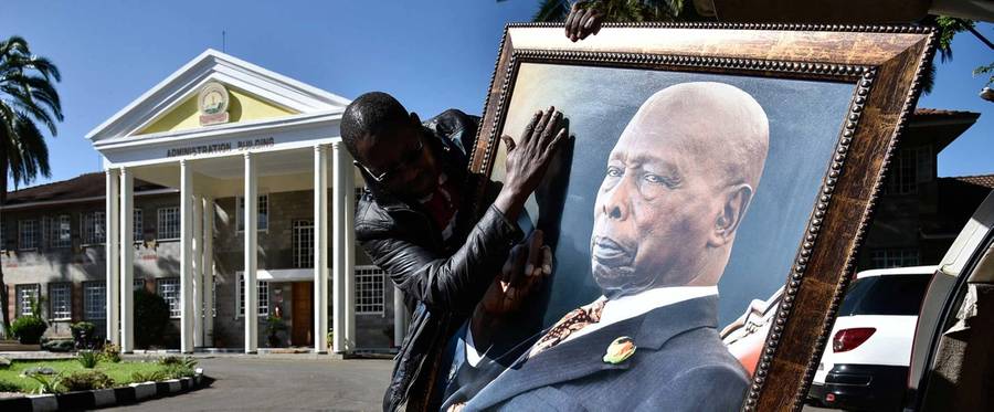 A man holding a portrait of the late former president of Kenya, Daniel arap Moi, in Nakuru on Feb. 7, 2020 
