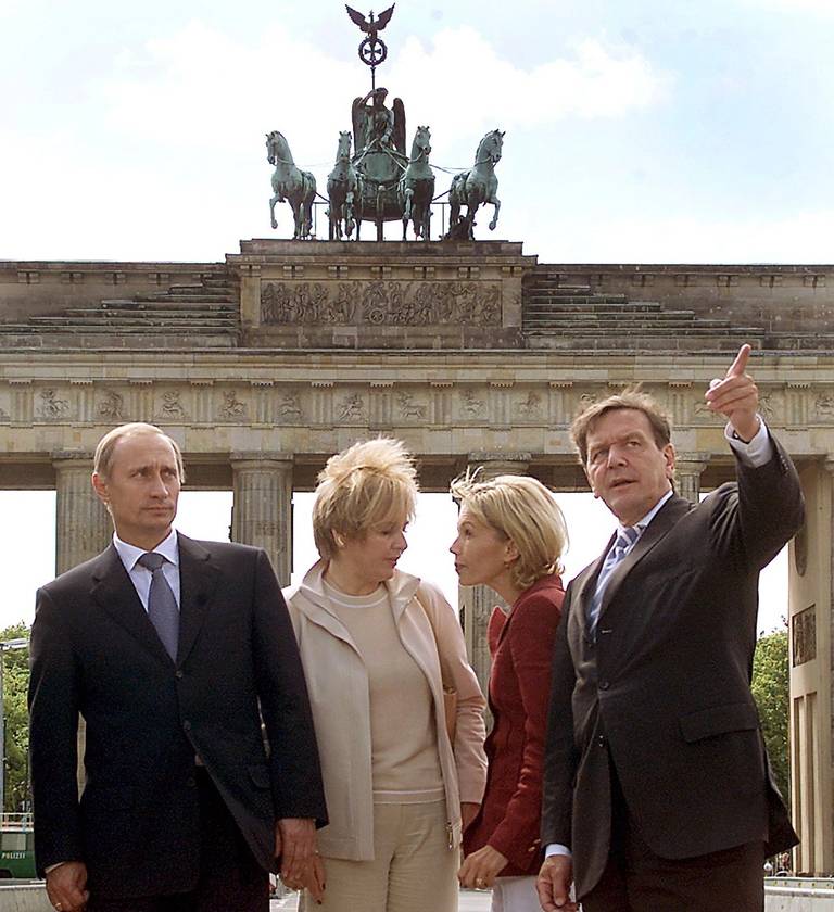 Russian President Vladimir Putin and then-German Chancellor Gerhard Schroeder with their then-wives, Lyudmila Putina and Doris Schroeder-Koepf, at the Brandenburg Gate in Berlin, 2000