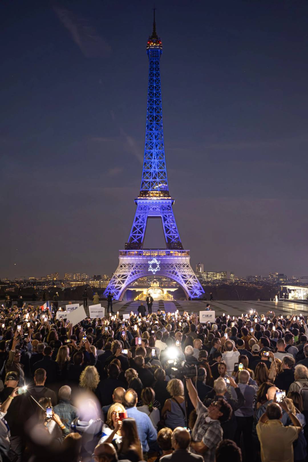 Crowd on Place du Trocadéro and Eiffel Tower illuminated with a Star of David in support of Israel following the Hamas attacks, October 9, 2023 in Paris