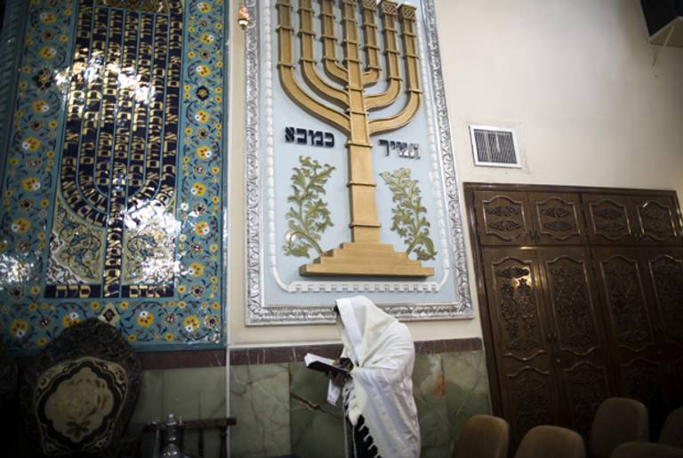 An Iranian Jewish man wearing a Tallit, reads the Torah during morning prayer at Youssef Abad synagogue in Tehran on September 30, 2013. (BEHROUZ MEHRI/AFP/Getty Images)
