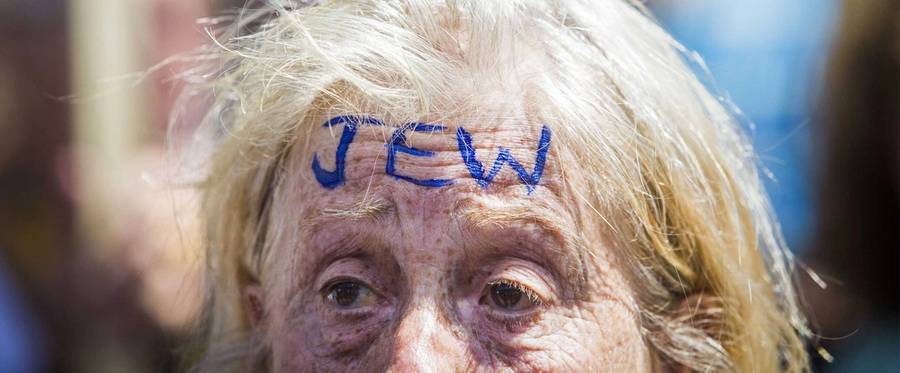 A woman attends an anti-fascist demonstration on Whitehall in central London on July 4, 2015, countering an anti-Jewish rally held by a group of far-right protesters. There were a couple of hundred anti-fascist demonstrators chanting over the rally held by the around 20 anti-Jewish, far-right demonstrators.