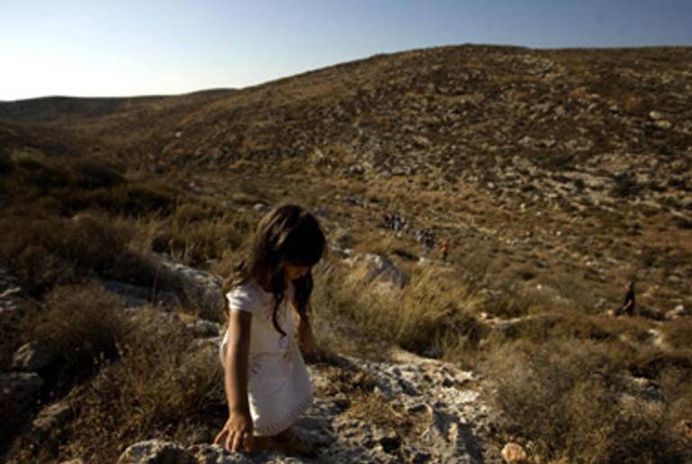 An Israeli settler girl walks up to the illegal outpost of Givat Tzuria(David Furst/AFP/Getty Images)