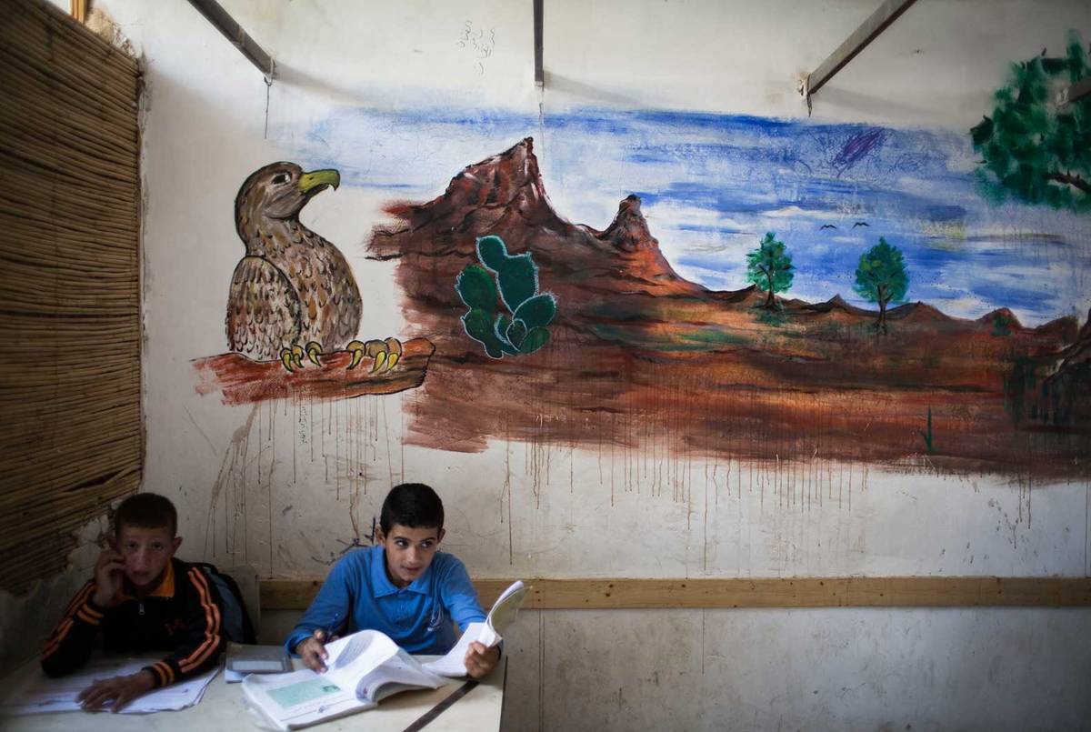Pupils take part in a classroom activity at a Palestinian Bedouin of Jahaline tribe school in the area of E1, not far from the settlement of Maale Adumim, on May 13, 2014. (Photo: Ilia Yefimovich/Getty Images)