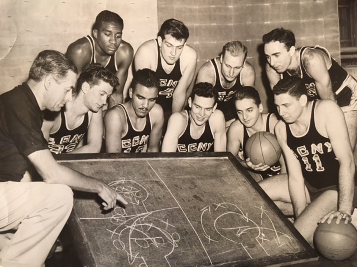 In a City College publicity photograph, head coach Nat Holman diagrams a play for members of the City College Beavers (Photo: Larry Gralla)