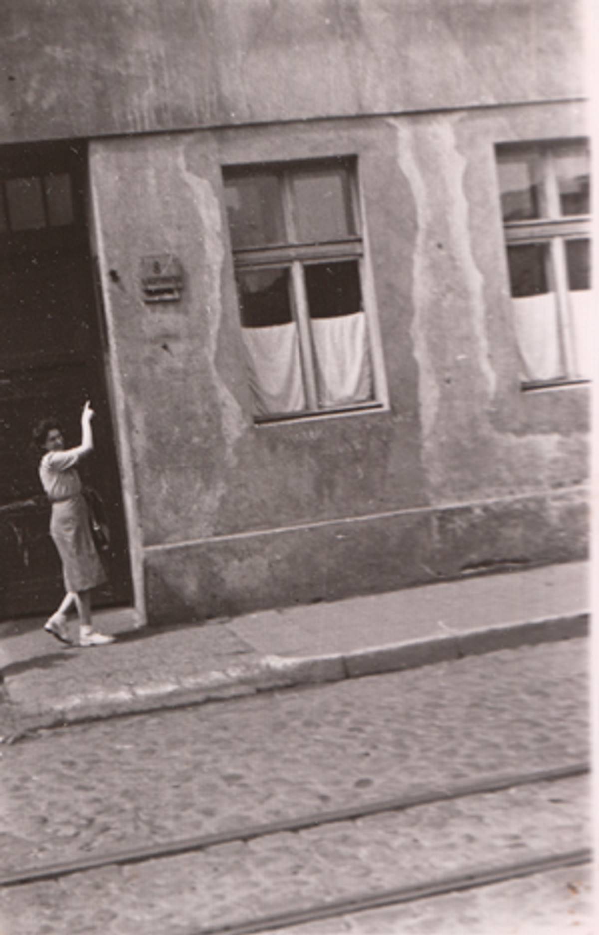 The author visiting Lodz, c. 1946, indicating the house in the ghetto where she lived.