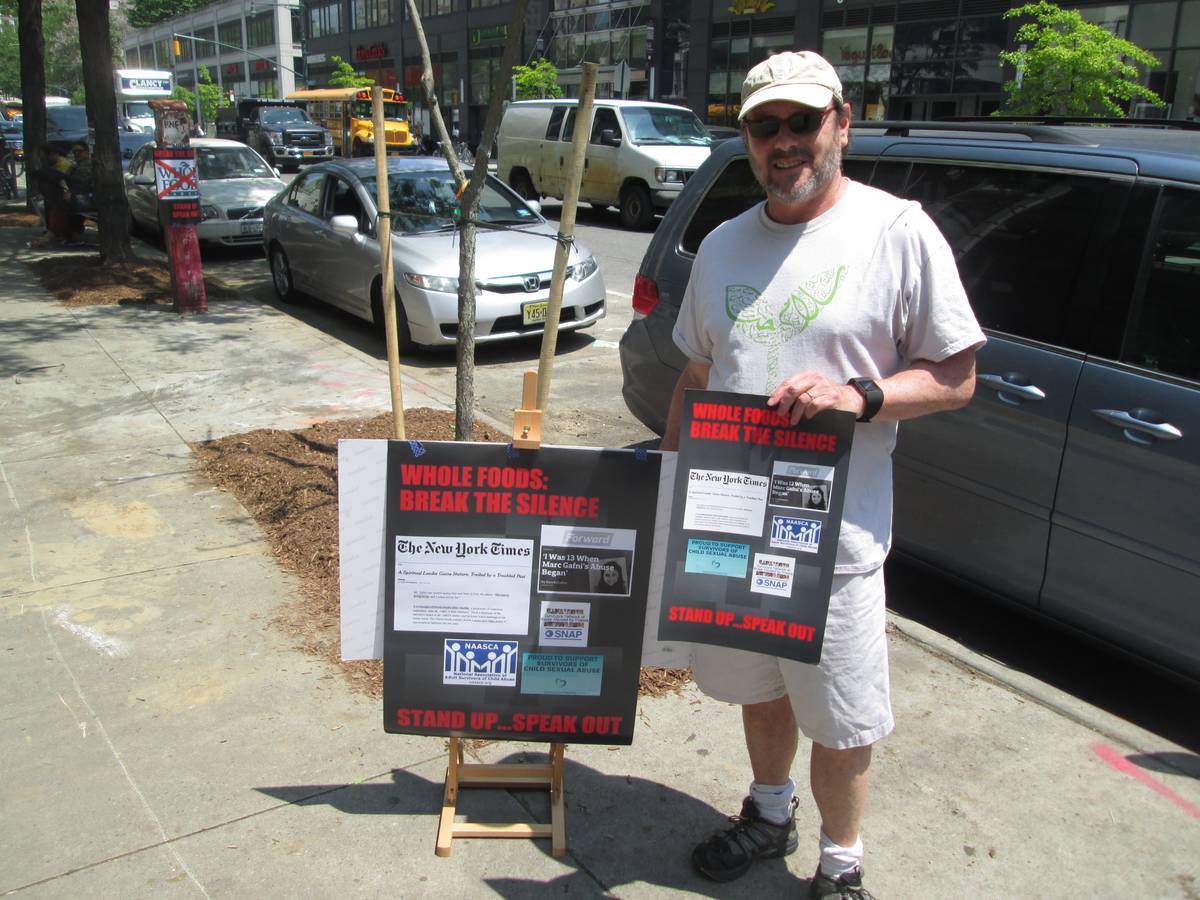 Lee Kravitz, a member of the Romemu congregation, demonstrates outside a New York City Whole Foods.
