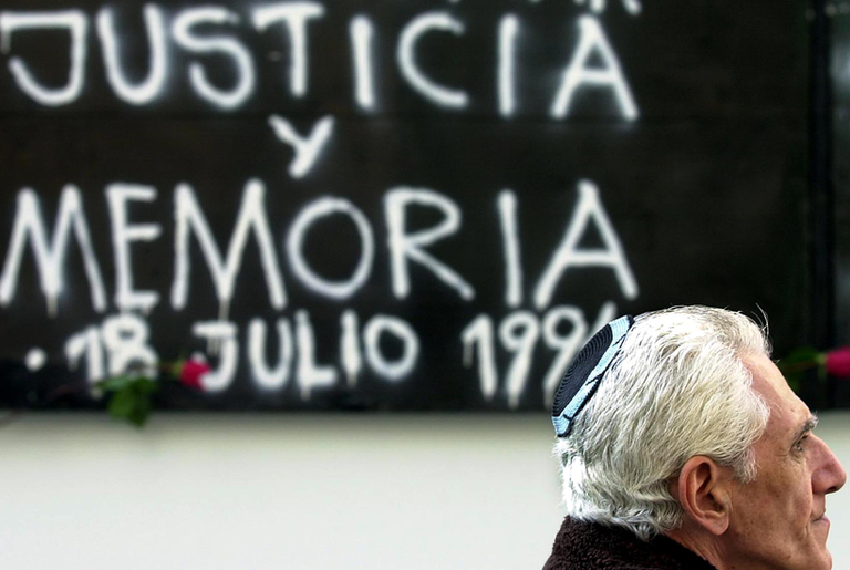 A man visits the site of the 1994 AMIA bombing on the seventh anniversary of the attack.(Miguel Mendez/AFP/Getty Images)