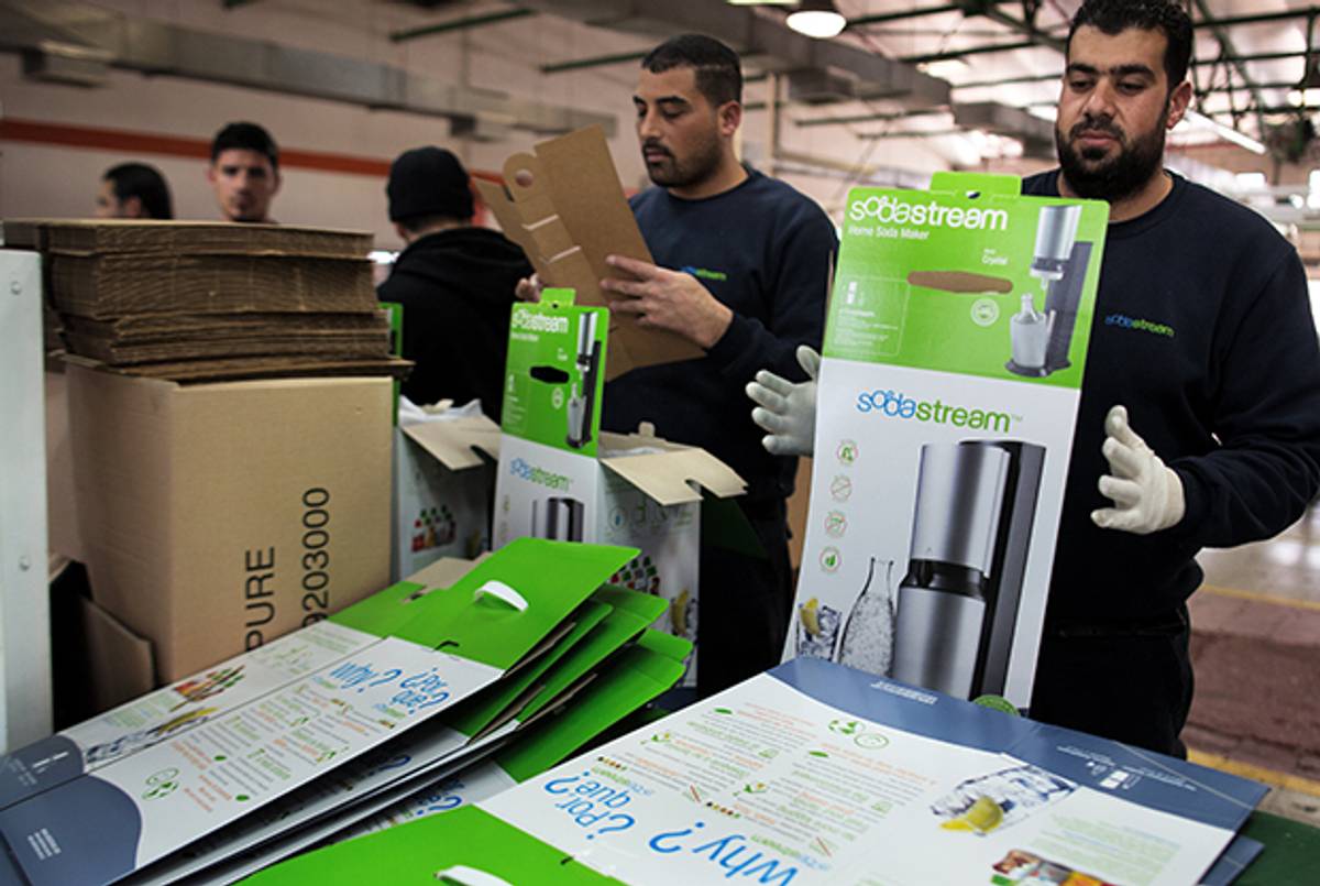 Palestinian workers at the Israeli SodaStream factory in the Mishor Adumim industrial park in the West Bank settlement of Maale Adumim on January 30, 2014. (MENAHEM KAHANA/AFP/Getty Images)