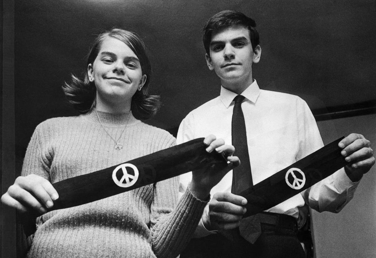 Mary Beth Tinker and her brother John display two black armbands, the objects of the U.S. Supreme Court's agreement on March 4, 1965, to hear arguments on how far public schools may go in limiting the wearing of political symbols. The children, both students at North High School, were suspended from classes along with three other students for wearing the bands to mourn the Vietnam War dead.