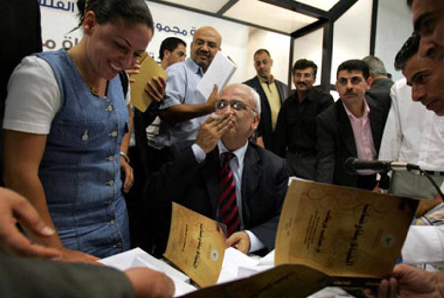 Erekat signing his book, Life Is Negotiations, last year.(Abbas Momani/AFP/Getty Images)