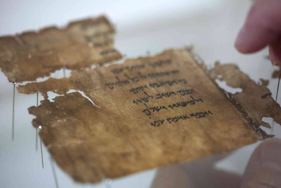 A conservation analyst from the Israeli Antiquities department prepares fragments of the Dead Sea scrolls on December 18, 2012 in Jerusalem, Israel. (Uriel Sinai/Getty Images)