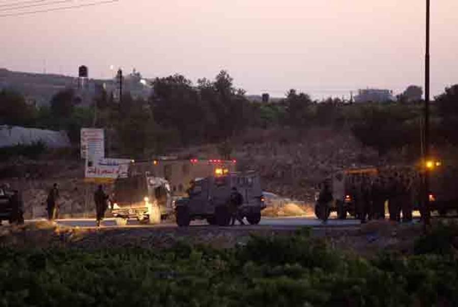 Israeli soldiers stand next to their vehicles on June 30, 2014 in the village of Halhul, near the West Bank town of Hebron, where the bodies of the three missing Israeli teenagers were found. (MENAHEM KAHANA/AFP/Getty Images)