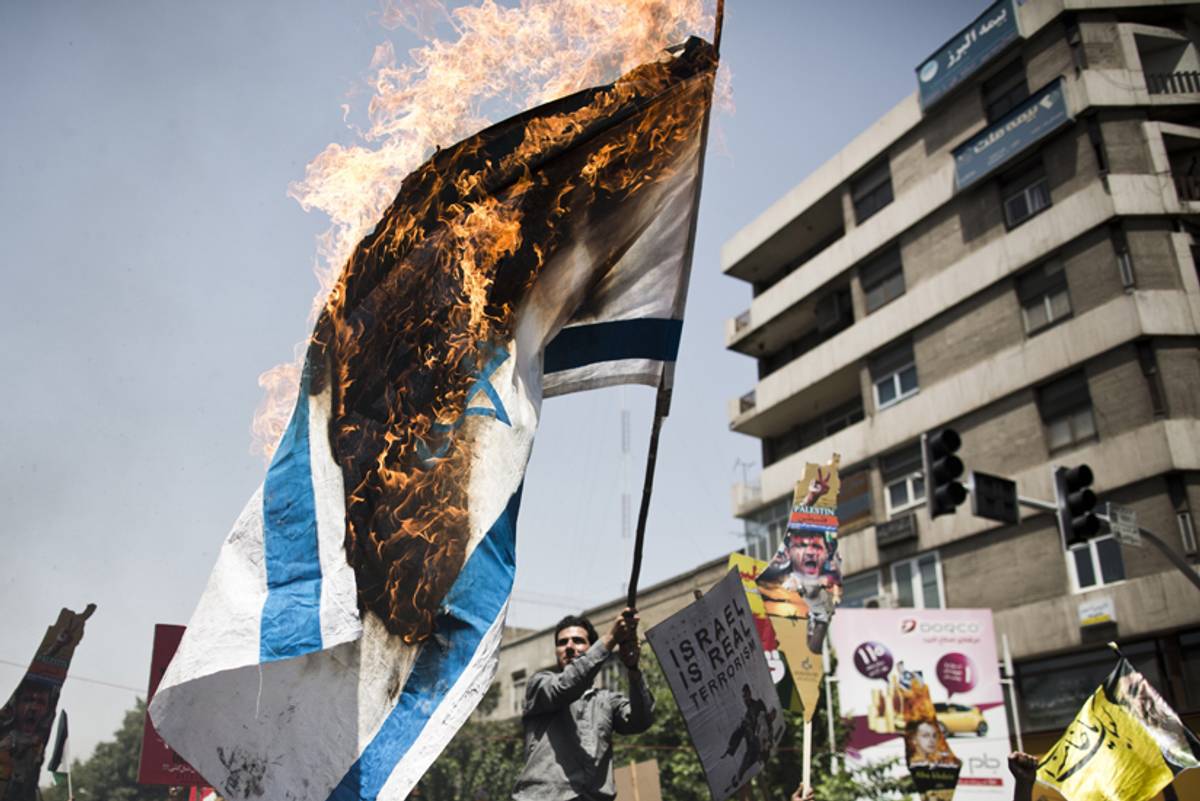 Iranian protestors burn an Israeli flag during a demonstration in Tehran on July 25, 2014.(BEHROUZ MEHRI/AFP/Getty Images)