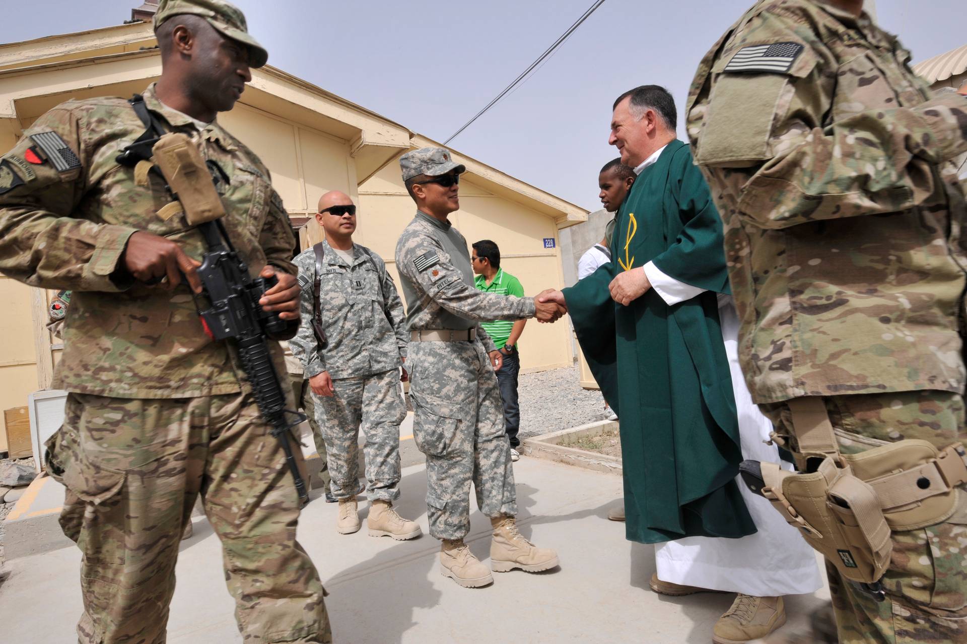 Chaplain Fintan Kilmurray greets U.S. soldiers after officiating a Sunday Mass service in Kandahar military base in southern Afghanistan, 2011