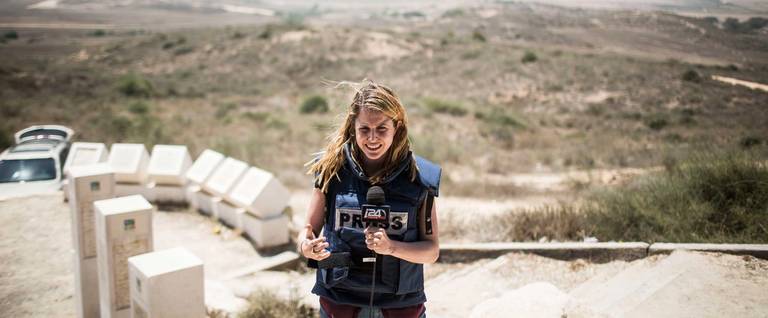 A TV reporter does a stand-up near the Israeli/Gaza border as a 24-hour ceasefire begins on July 27, 2014.