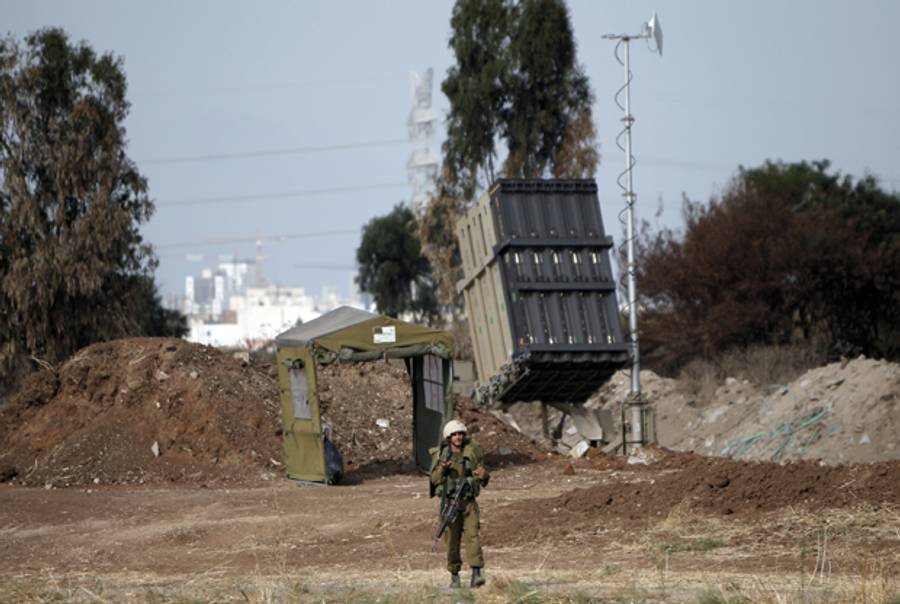 An Israeli soldier walks close to an Iron Dome battery on July 9, 2014, placed close to the city of Tel Aviv. (AHMAD GHARABLI/AFP/Getty Images)
