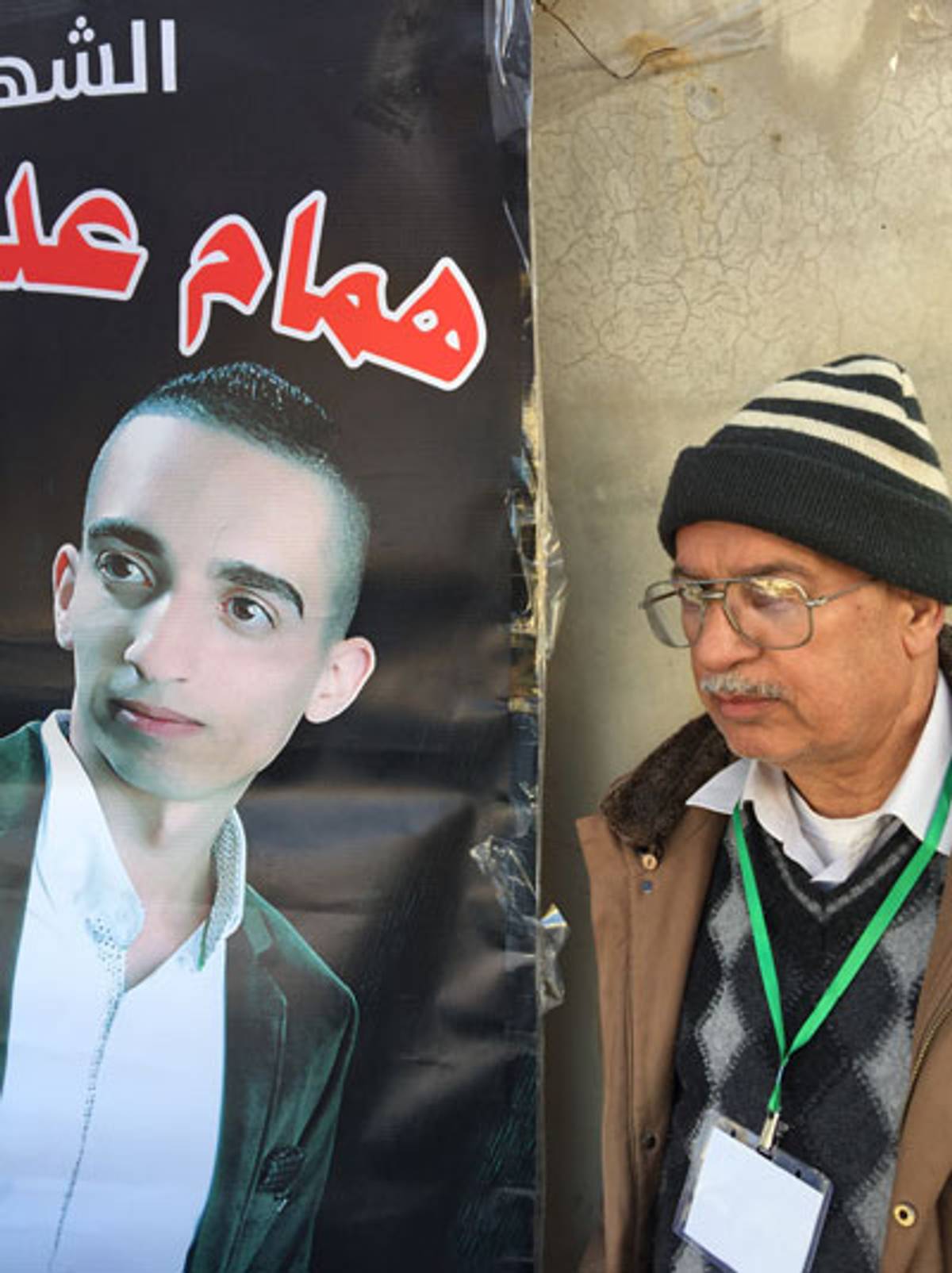 Adnan Asa’id stands next to a banner depicting his son Hamam, 23, shot dead while trying to stab an Israeli soldier in Hebron, Oct. 27, 2015. (Photo: Elhanan Miller)